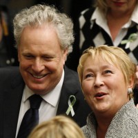 Quebec's Premier Charest smiles as he speaks with the Parti Quebecois leader Marois prior to the questions period at the National Assembly in Quebec City